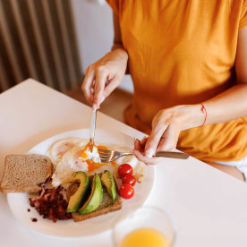 Close-up shot of unrecognizable young woman having healthy breakfast at home