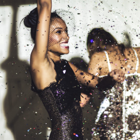 Woman in cocktail dress celebrating